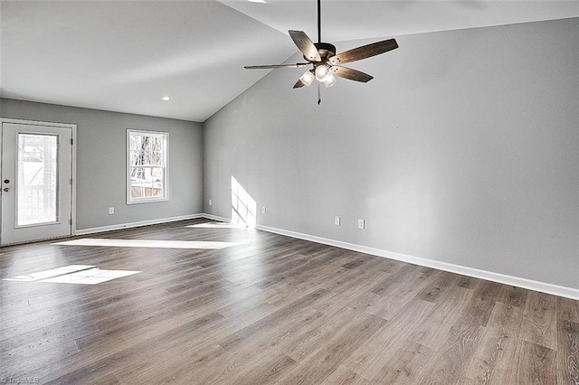 spare room featuring ceiling fan, wood-type flooring, and vaulted ceiling