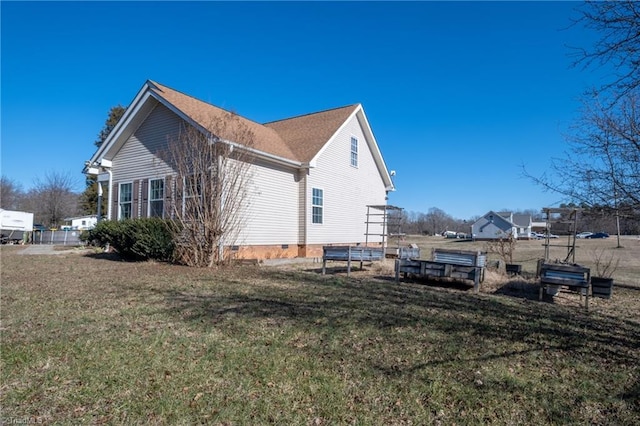 view of side of home featuring a yard