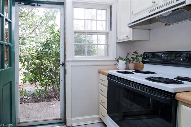 kitchen featuring under cabinet range hood, white cabinetry, and electric range