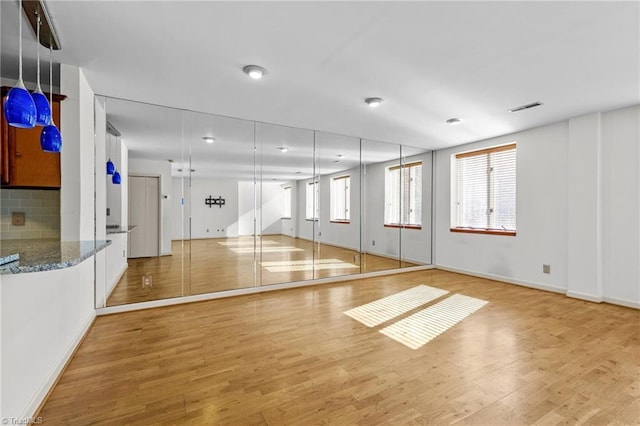 workout room with light hardwood / wood-style floors