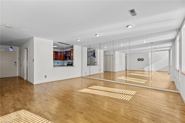 exercise room featuring light hardwood / wood-style floors