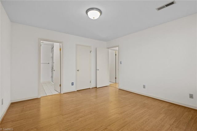 unfurnished room with light hardwood / wood-style floors