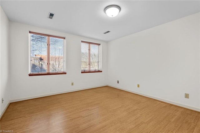 unfurnished room with light hardwood / wood-style floors