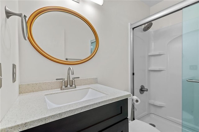 bathroom with walk in shower, vanity, and toilet