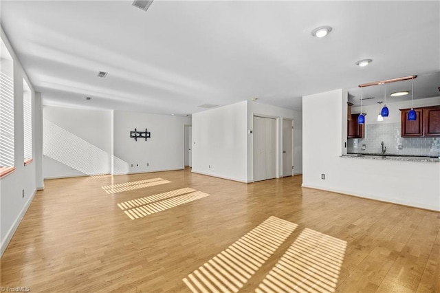 unfurnished living room featuring light hardwood / wood-style flooring