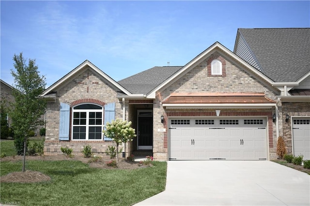 view of front of house with a garage and a front yard