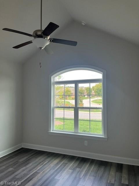 spare room featuring hardwood / wood-style flooring, lofted ceiling, ceiling fan, and plenty of natural light