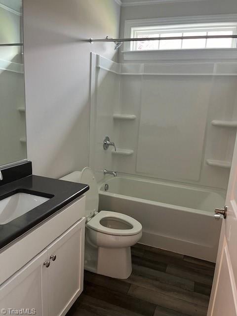 full bathroom with vanity, hardwood / wood-style floors, toilet, and shower / bathtub combination