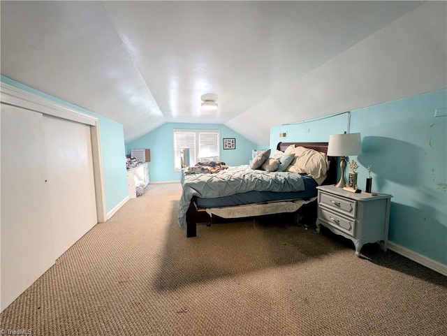 bedroom featuring light carpet and vaulted ceiling