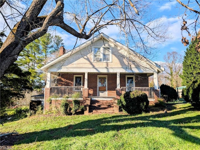 view of front facade with a front lawn and covered porch