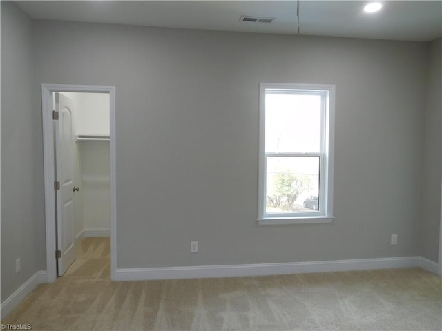 4391 Old Town Dr, Winston-Salem, NC 27106 - unfurnished bedroom with a walk in closet, light colored carpet, visible vents, and baseboards