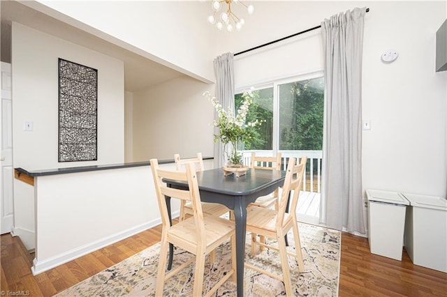 dining space featuring a chandelier and dark hardwood / wood-style flooring