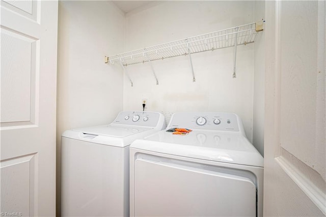 washroom with washing machine and clothes dryer