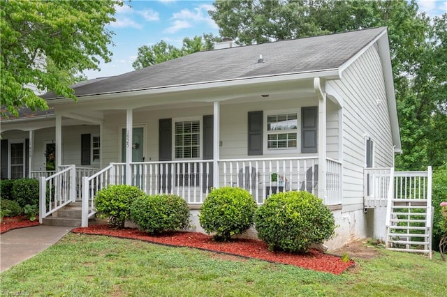 view of front of home featuring covered porch and a front lawn