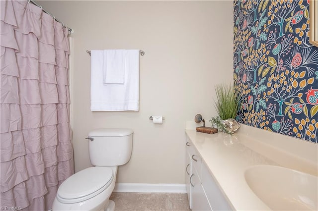 bathroom featuring tile patterned flooring, vanity, and toilet