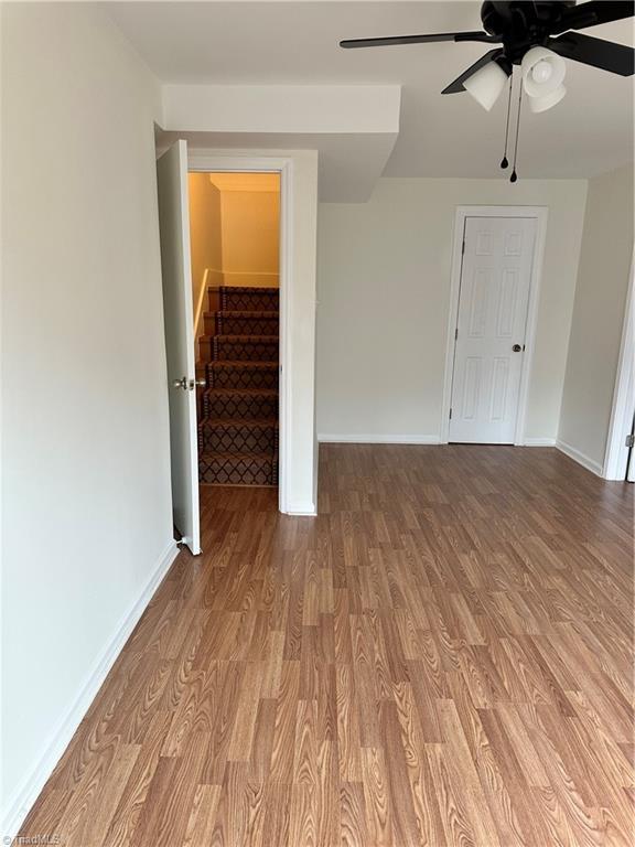 spare room featuring light hardwood / wood-style flooring and ceiling fan