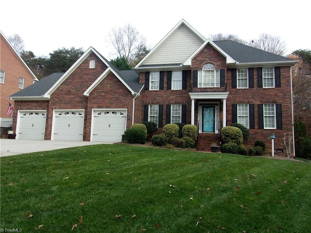 colonial home with a garage and a front lawn