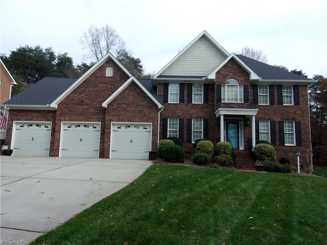 colonial inspired home with a front yard and a garage