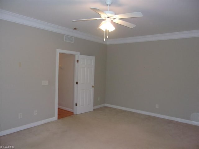 carpeted empty room featuring ceiling fan and crown molding