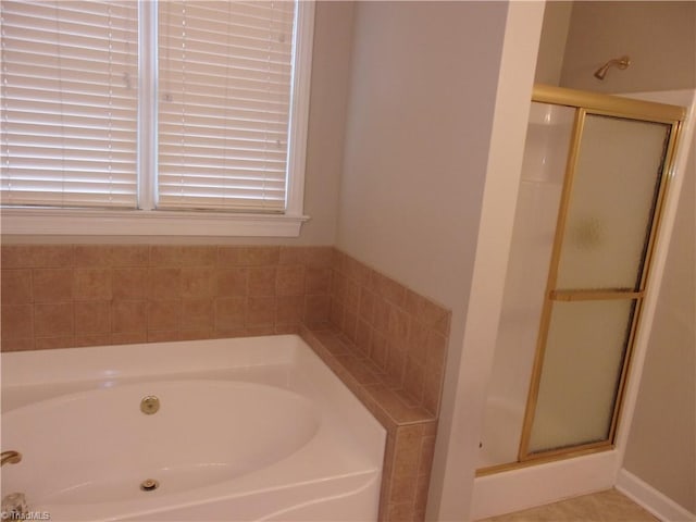 bathroom featuring shower with separate bathtub