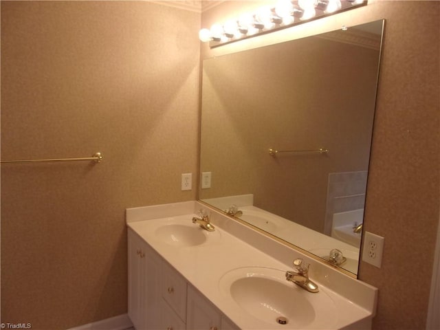 bathroom with crown molding and vanity