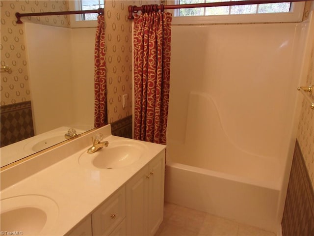 bathroom with tile patterned floors, vanity, shower / tub combo with curtain, and a healthy amount of sunlight