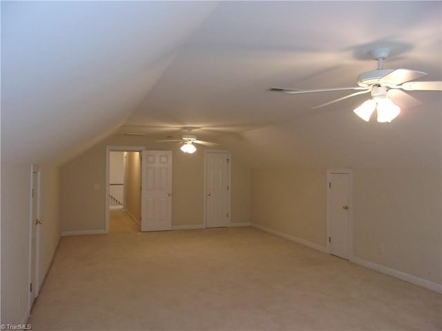 additional living space with light carpet, ceiling fan, and lofted ceiling