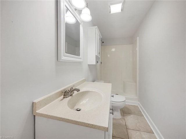 full bath featuring toilet, a shower stall, vanity, baseboards, and tile patterned floors