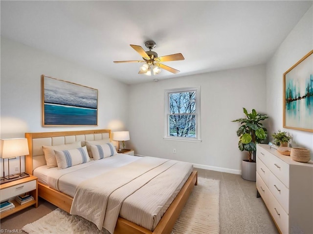 bedroom featuring light colored carpet, ceiling fan, and baseboards