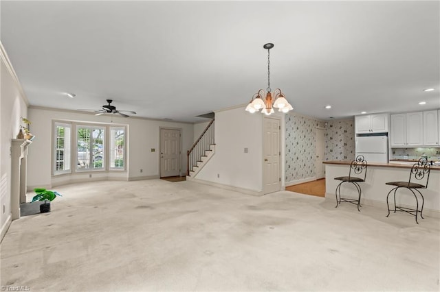 440 Marshall View Ct, Winston-Salem, NC 27101 - unfurnished living room featuring light carpet, crown molding, stairs, a chandelier, and ceiling fan