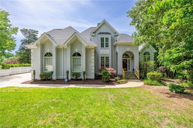 view of front of home with stucco siding and a shingled roof
