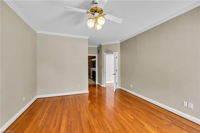 unfurnished room featuring ceiling fan, wood finished floors, baseboards, and ornamental molding