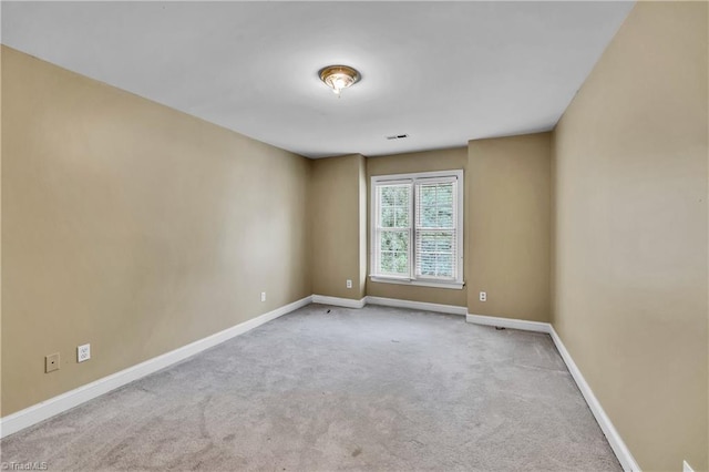 unfurnished room with carpet floors and baseboards