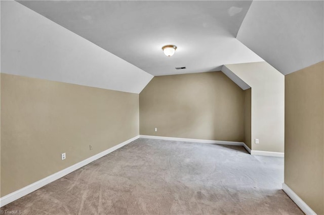 bonus room featuring carpet floors, vaulted ceiling, and baseboards