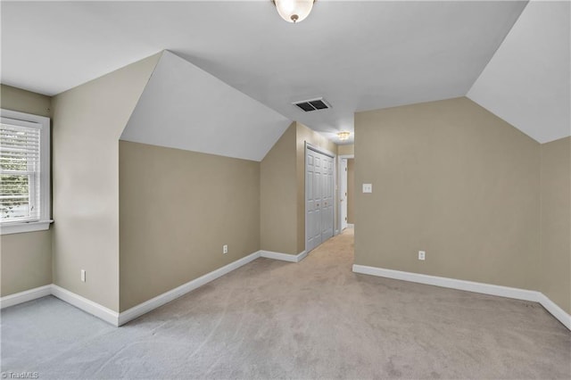 bonus room featuring lofted ceiling, carpet, and baseboards