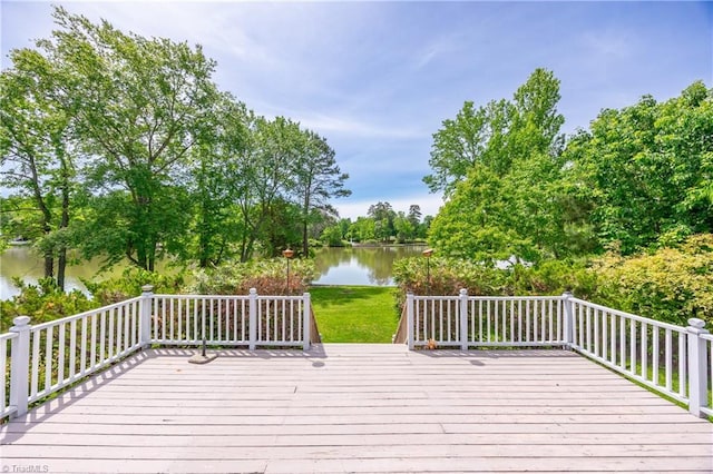deck with a water view and view of scattered trees