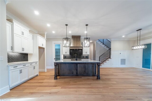 unfurnished room with ceiling fan, light hardwood / wood-style flooring, plenty of natural light, and a tray ceiling