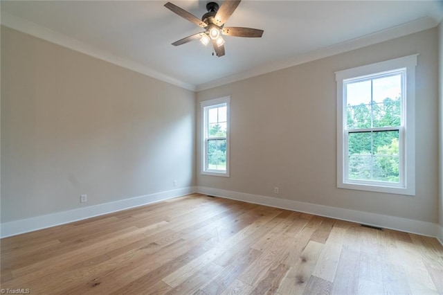 empty room featuring light wood-type flooring, crown molding, ceiling fan, and a wealth of natural light