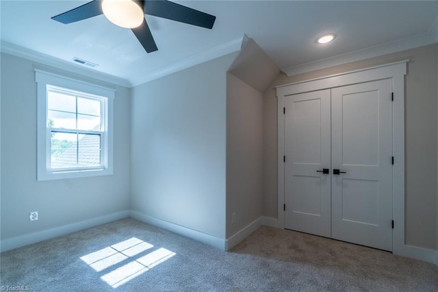 unfurnished bedroom with a closet, ceiling fan, and light colored carpet