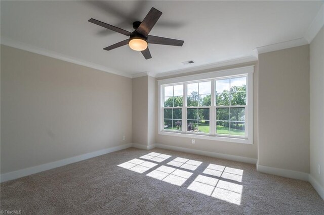 carpeted spare room featuring crown molding and ceiling fan