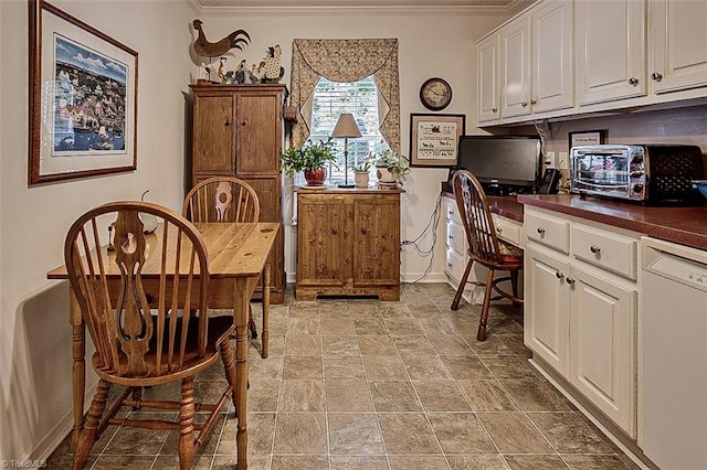 dining room with built in desk and crown molding