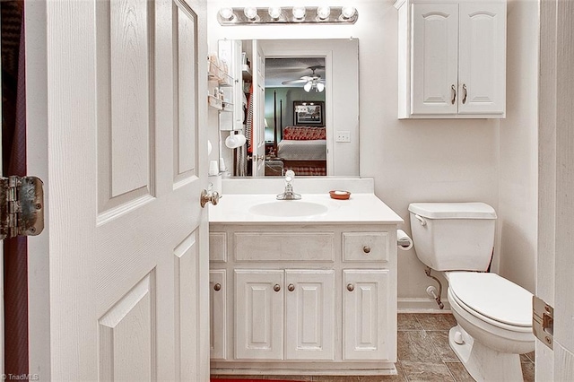 bathroom with vanity, toilet, ceiling fan, and tile patterned floors