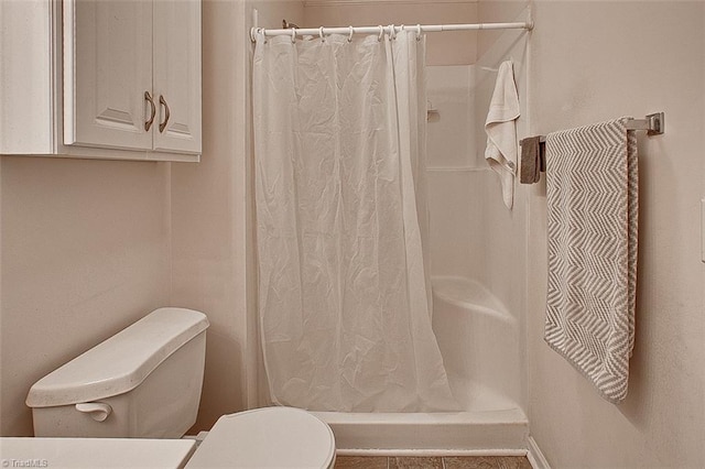 bathroom with walk in shower and toilet