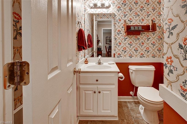 bathroom with vanity, toilet, and tile patterned floors