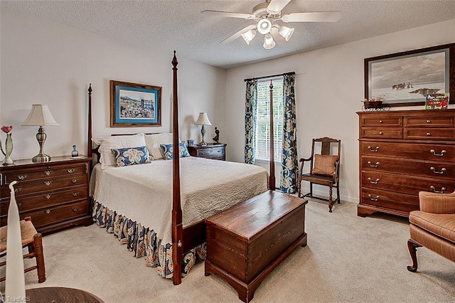 carpeted bedroom featuring a textured ceiling and ceiling fan