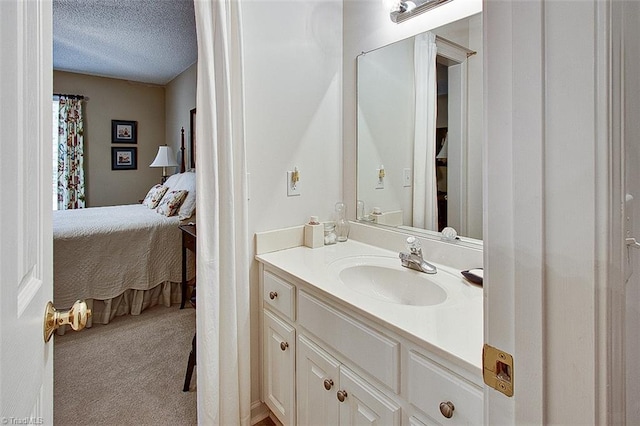 bathroom with a textured ceiling and vanity