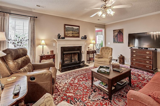 carpeted living room featuring a textured ceiling, ornamental molding, and ceiling fan