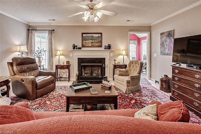 living room with ornamental molding, a textured ceiling, and ceiling fan