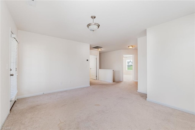 empty room with baseboards and light colored carpet