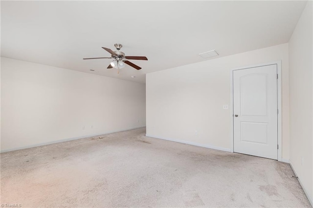 unfurnished room featuring light carpet, ceiling fan, and baseboards